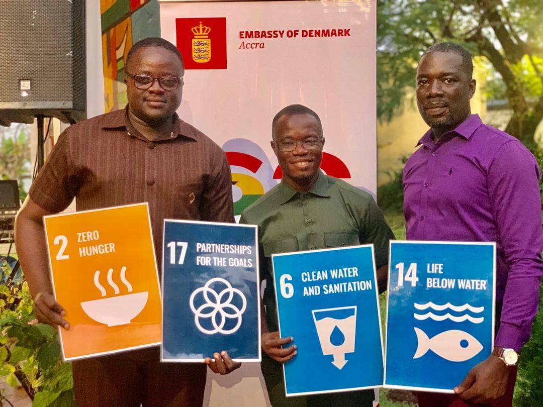 AYWF delegates holding Sustainable Development Goal placards, including SDG 6 on clean water and sanitation, at an Embassy of Denmark event in Accra